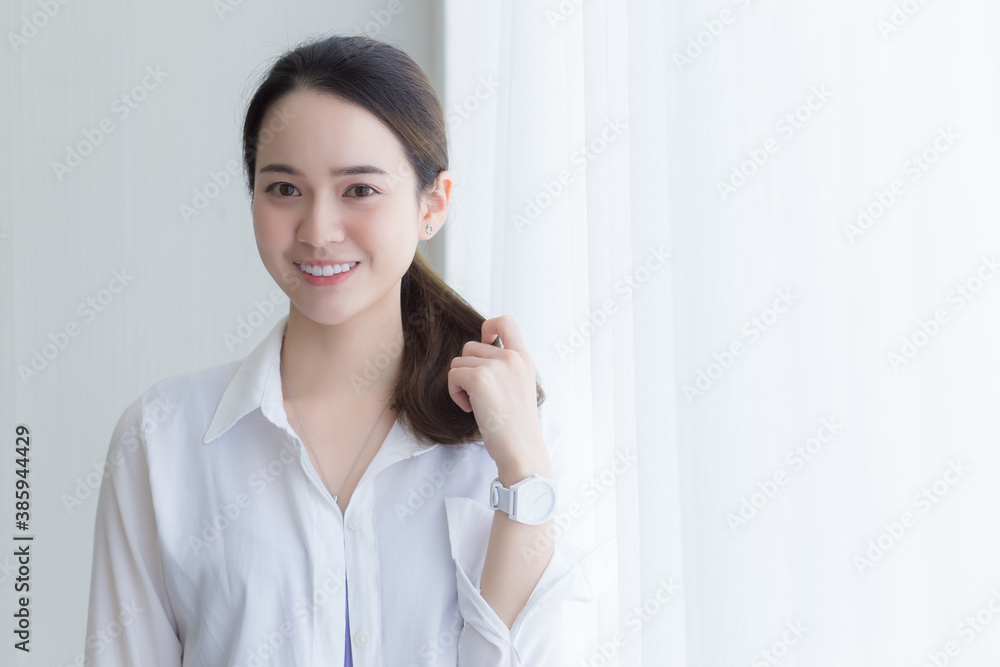 Asian beautiful woman in white shirt is smiling. Asian beautiful woman in white shirt is smiling.