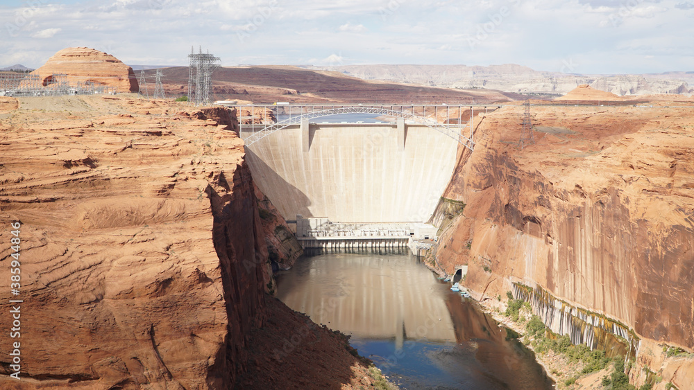 Glen Canyon Dam with steep sandstone cliffs into Colorado River near Lake Powell in Arizona, USA. Glen Canyon Dam with steep sandstone cliffs into Colorado River near Lake Powell in Arizona, USA.
