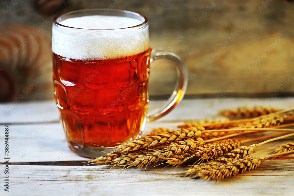 Fototapeta premium Selective focus. Fresh live wheat beer and ears of wheat. Brewery concept.