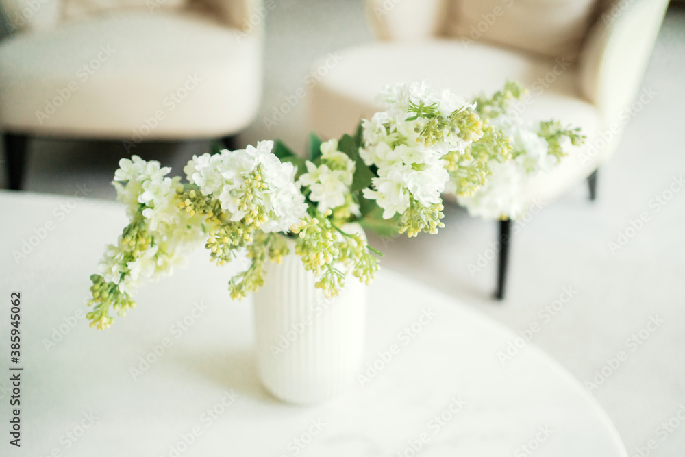 flowers are on the table in a glass, stylish cozy beautiful apartment flowers are on the table in a glass, stylish cozy beautiful apartment