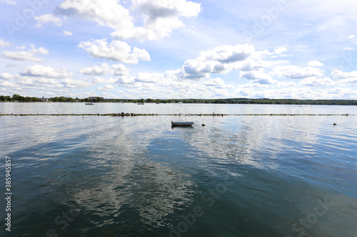 Rowboat on Canandaigua lake.  Morning clouds reflecting on the calm lake in Canandaigua New York photo