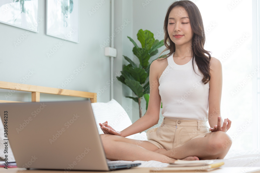 Asian woman play and learn yoga online in labtop at home. Asian woman play and learn yoga online in labtop at home.