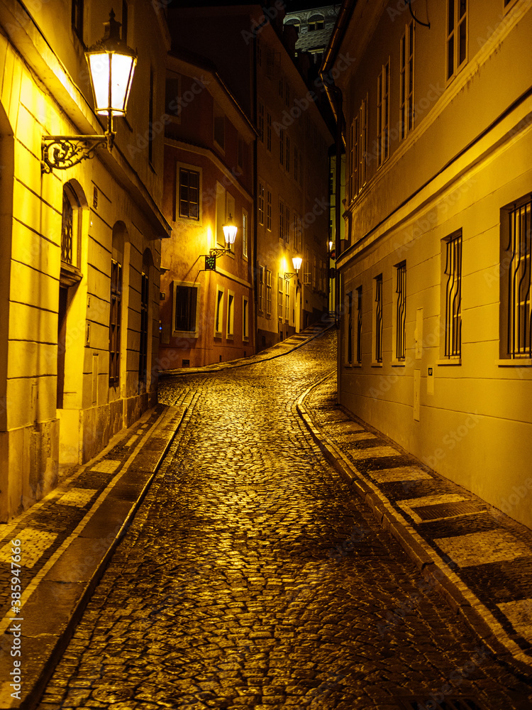 Old cobblestoned night street in Prague historic old town