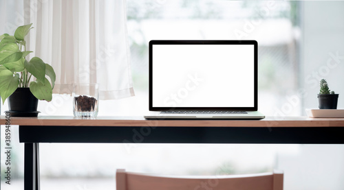 Wallpaper Mural Mockup blank screen laptop on wooden counter table in co-workspace, copy space. Torontodigital.ca