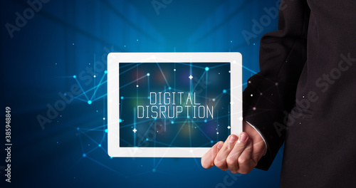 Wallpaper Mural Young business person working on tablet and shows the digital sign: DIGITAL DISRUPTION Torontodigital.ca