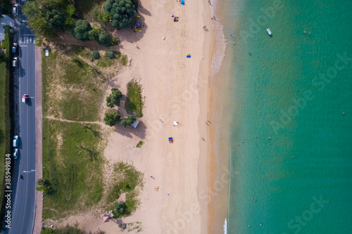 Top view aerial view photo from flying drone of tropical beach beautiful sea scenery landscape with turquoise water surface in the phuket island.