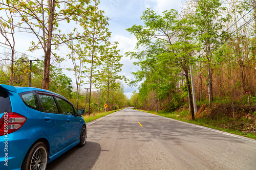 Car on Asphalt road with mountain green forest Transportation to travel concept and free space for summer text and travel transportation background.