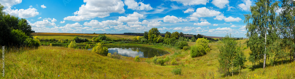 Panoramic summer rural landscape with lake and farm fields in sunny day. Panoramic summer rural landscape with lake and farm fields in sunny day.