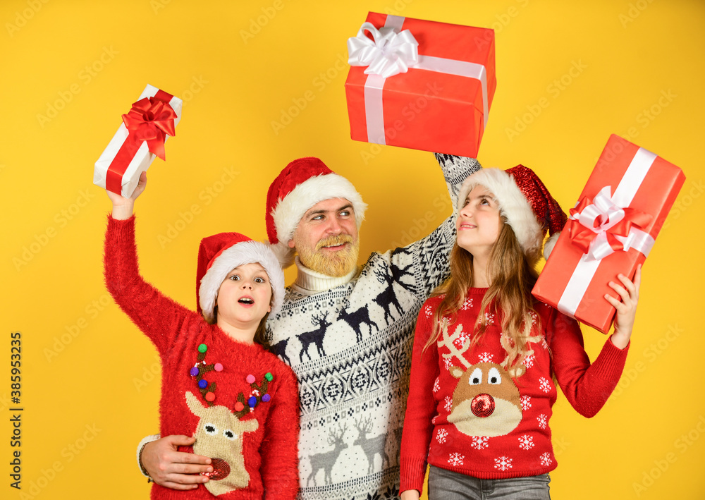 Fototapeta premium Presents for everybody. Family shopping. Christmas sale. Dad kids having fun. Father and little daughters celebrate new year together. Christmas becomes special with children. Christmas eve concept