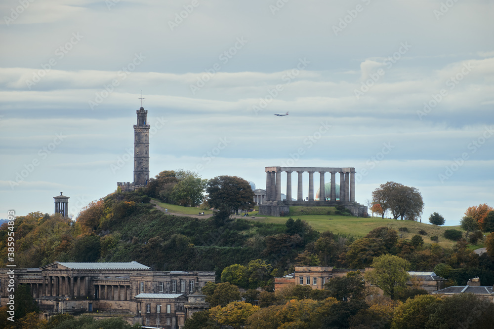 Amazing cityscape view of the Edinburgh city. Calton Hill with some of monuments - the National Monument, Dugald Stewart Monument, Nelson's Monument, the Old Royal High School.