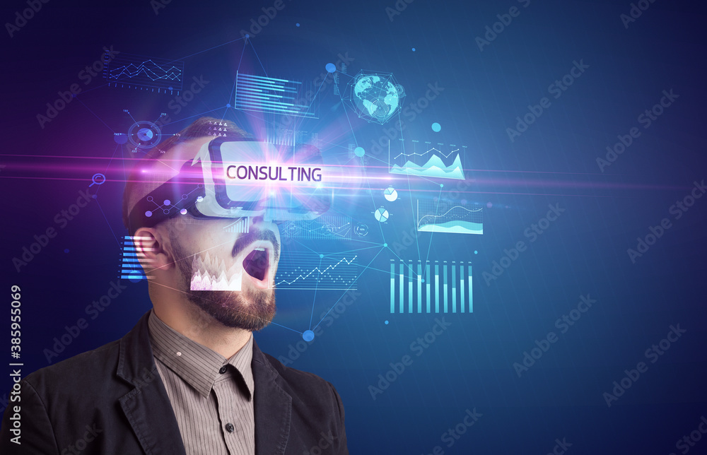 Businessman looking through Virtual Reality glasses with CONSULTING inscription, new business concept Businessman looking through Virtual Reality glasses with CONSULTING inscription, new business concept