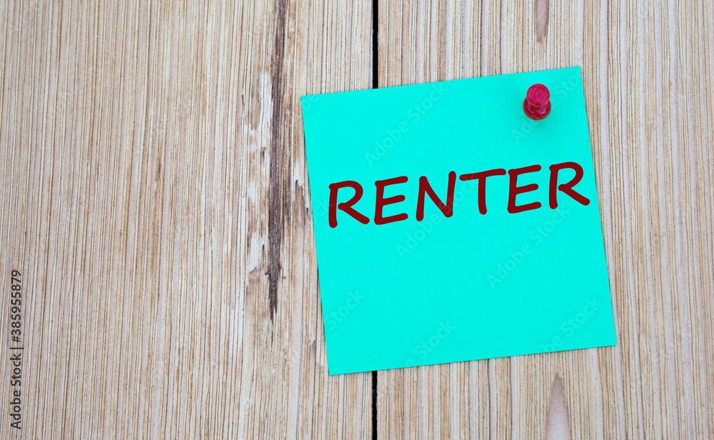 RENTER - word written on a green sheet for notes, which is pinned to a light wooden board RENTER - word written on a green sheet for notes, which is pinned to a light wooden board