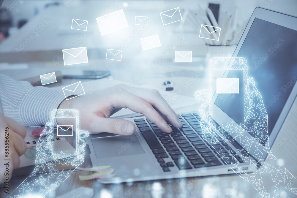 Envelop hologram drawing with businessman working on computer on background. Electronic mail concept. Double exposure. Envelop hologram drawing with businessman working on computer on background. Electronic mail concept. Double exposure.