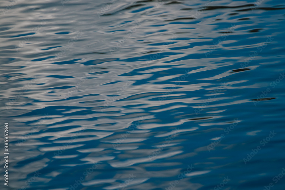 Naklejka premium Close river water background, blue water ripples texture.