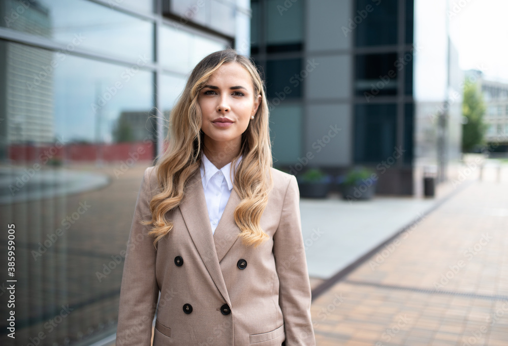 Fototapeta premium Smiling businesswoman in front of her office