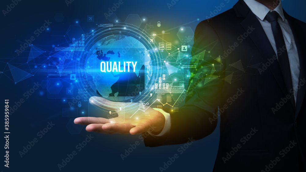 Elegant hand holding QUALITY inscription, digital technology concept Elegant hand holding QUALITY inscription, digital technology concept