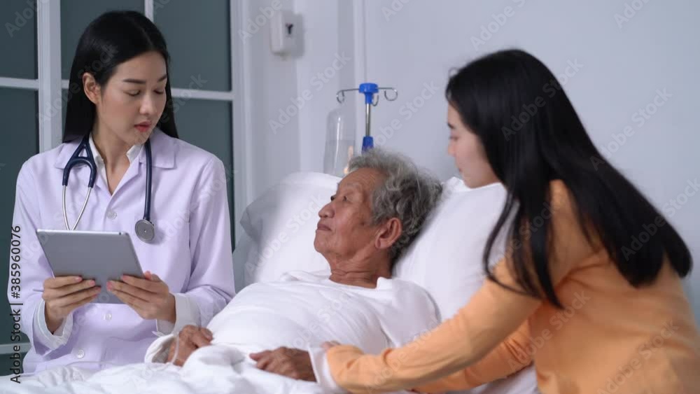 Doctor visiting old senior woman and medic talking with an elderly woman giving consultation and health checkup in hospital bed Doctor visiting old senior woman and medic talking with an elderly woman giving consultation and health checkup in hospital bed