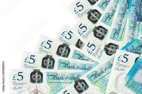 5 British pounds bills lies in different order isolated on white. Local banking or money making concept photo