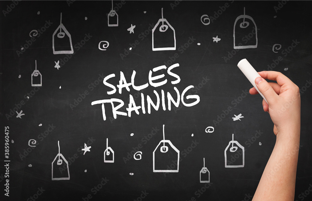 Hand drawing SALES TRAINING inscription with white chalk on blackboard, online shopping concept Hand drawing SALES TRAINING inscription with white chalk on blackboard, online shopping concept