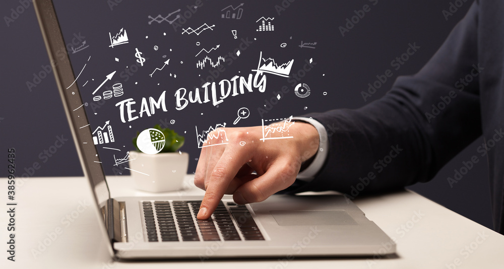 Businessman working on laptop with TEAM BUILDING inscription, modern business concept Businessman working on laptop with TEAM BUILDING inscription, modern business concept