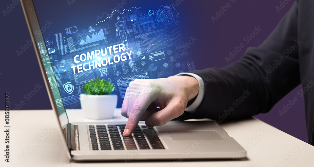 Businessman working on laptop with COMPUTER TECHNOLOGY inscription, cyber technology concept Businessman working on laptop with COMPUTER TECHNOLOGY inscription, cyber technology concept