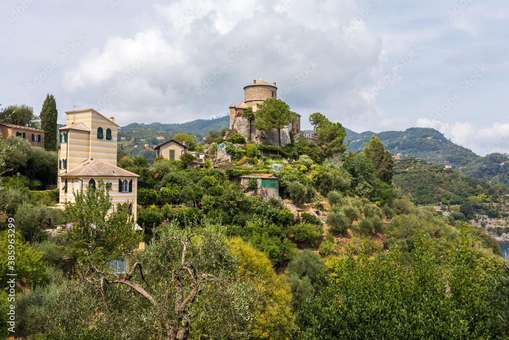 View of Castello Brown, 16th century museum in Portofino in Italy. Trees and greenery around the historic building.