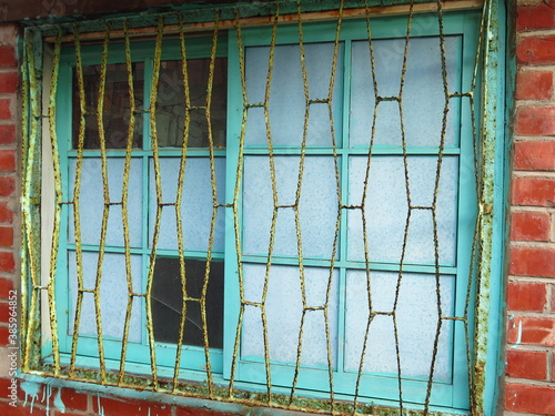 the ancient brick house with green behind bars design for traditional countryside image of Taiwan