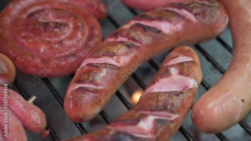 ausages in close-up on a charcoal grilll photo