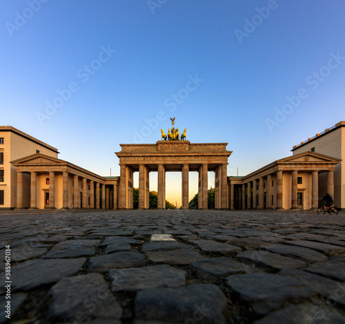 The German capital Berlin Brandenburg Gate House in sunrise with sun star