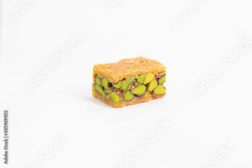 Leinwand Poster Middle eastern, Turkish sweet pastry baklava with pistachio isolated on white ba
