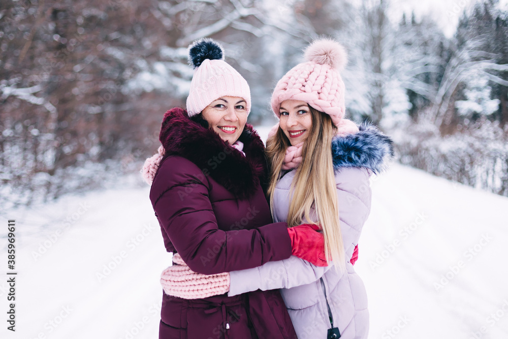 Young woman with her daughter on a walk on a winter day. The wom