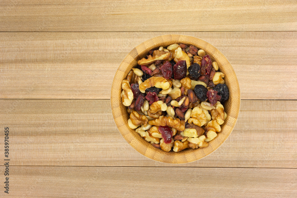 Top view of a bowl of healthy trail mix on a wood background. Top view of a bowl of healthy trail mix on a wood background.
