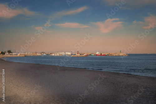 Coast Villajoiosa of Spanish town. Mediterranean City Costa Blanca in the Province of Alicante, Valencian Community Spain. Port view with yachts and vessels. Lonely lighthouse. Image with copy space.