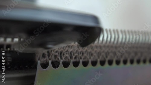 Female hands making textile on weaving machine at factory. Knitting machine Close up of weaving fabric on loom machine. Manufacturing knitted fabric on manual knitting equipment. Textile industry