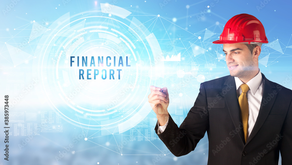 Handsome businessman with helmet drawing FINANCIAL REPORT inscription, contruction business concept Handsome businessman with helmet drawing FINANCIAL REPORT inscription, contruction business concept