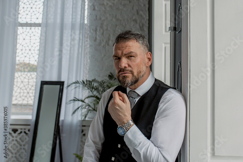Принти на полотні handsome mature courageous stylish scotsman (gay) in kilt by the window