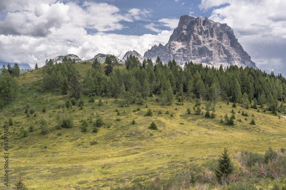 Obraz premium Monte Pelmo, a mountain of the Dolomites, resembles a giant rock, isolated from other peaks, as seen from Col dei Baldi (Baldi pass) above Alleghe village, Province of Belluno, South Tirol, Italy.