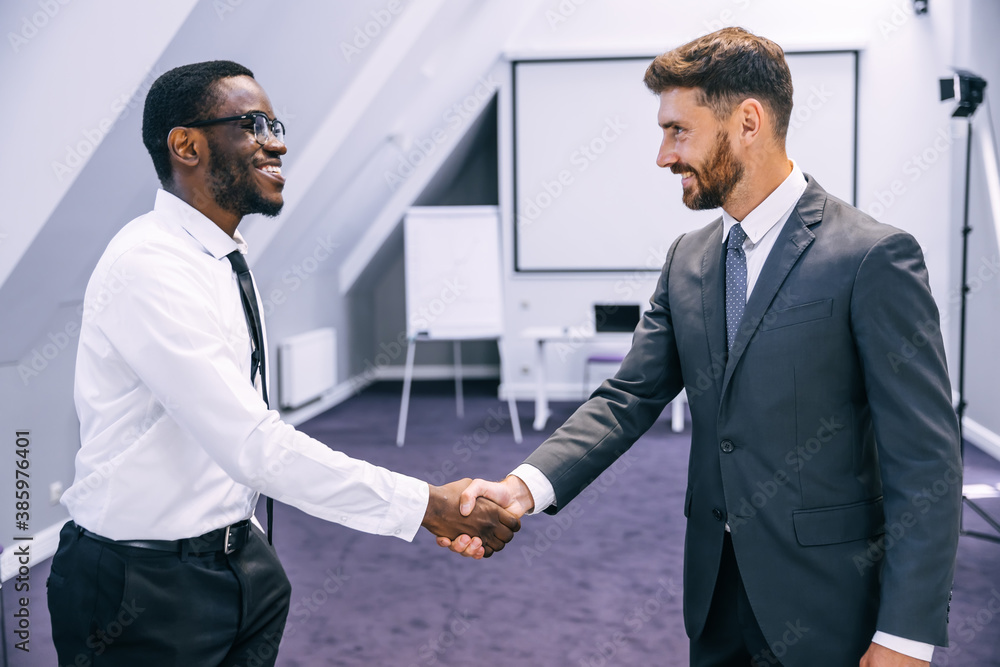 Commander shaking hands with new employee congratulates on the start of a new job. Teamwork concept for business partners, meeting and greeting concept. Commander shaking hands with new employee congratulates on the start of a new job. Teamwork concept for business partners, meeting and greeting concept.