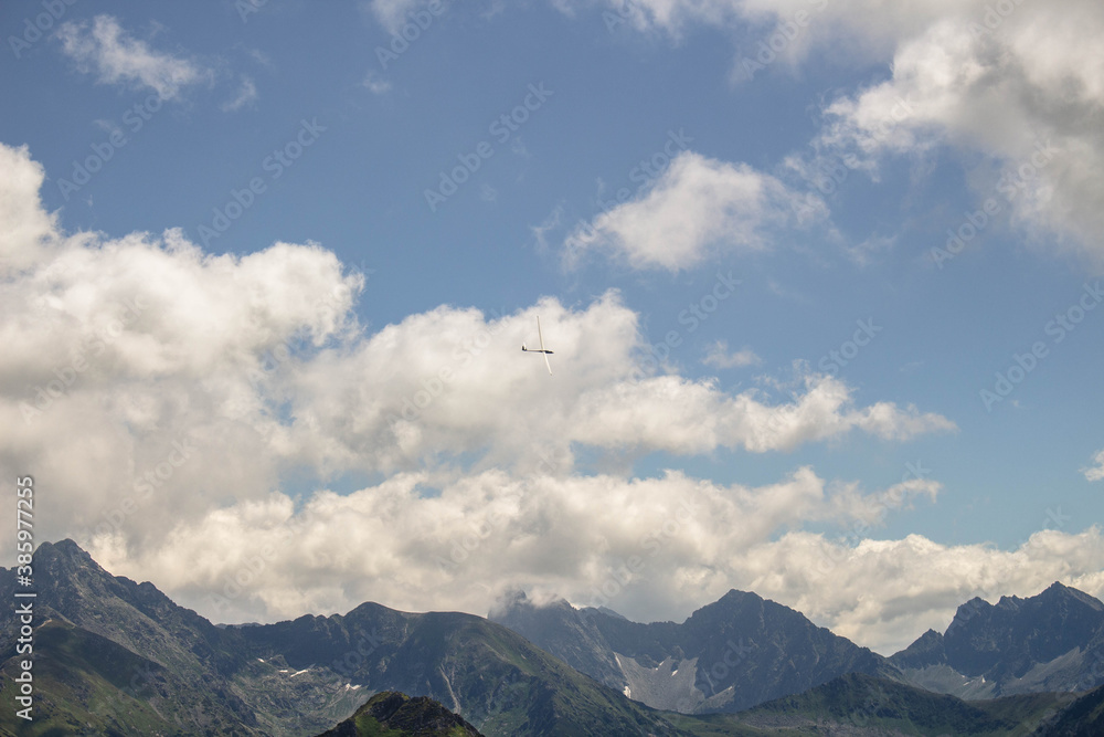 Glider flying over the Tatra Mountains. Seen from Kopa Kondradcka mountain.