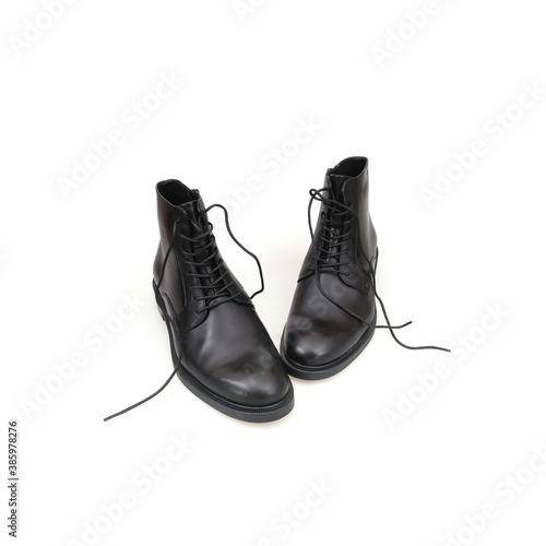 Fashionable black boots for men and women isolated on white background
