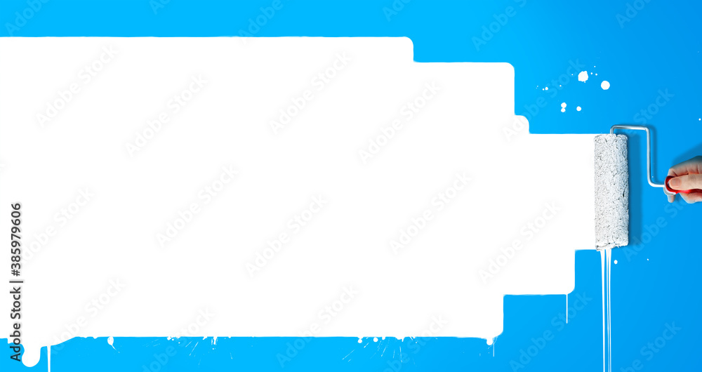Paint roller painting white paint in a blue wall. Creative copy space for advertising or marketing. Paint roller painting white paint in a blue wall. Creative copy space for advertising or marketing.