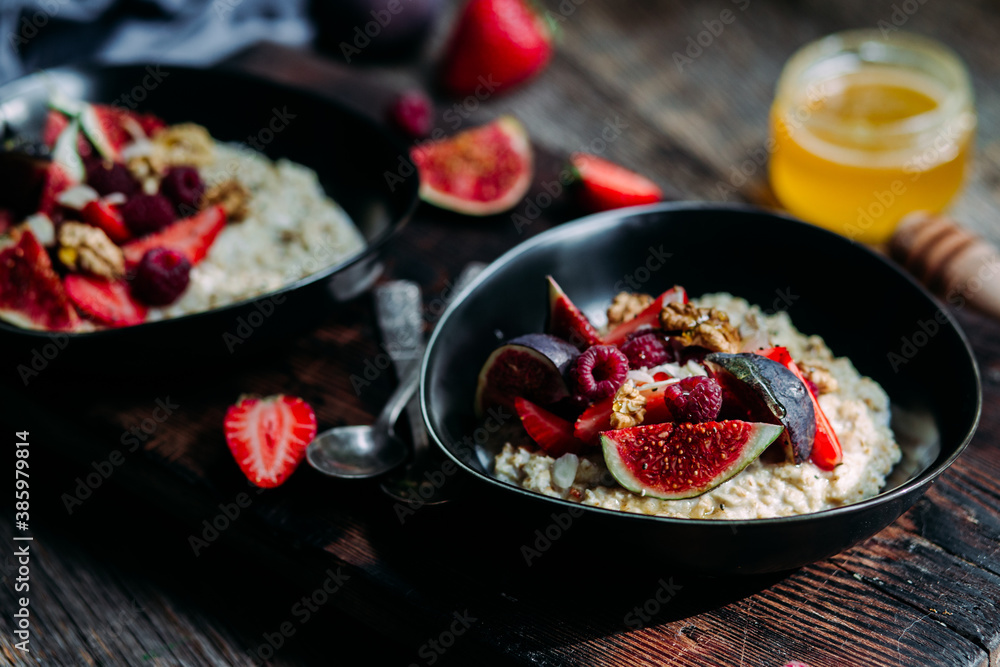Oatmeal with figs, chia, raspberries and strawberries. Healthy Breakfast