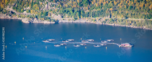 Salmon Fish farm in fjord next to montains - North Sea Bergen / Stavanger Norway photo