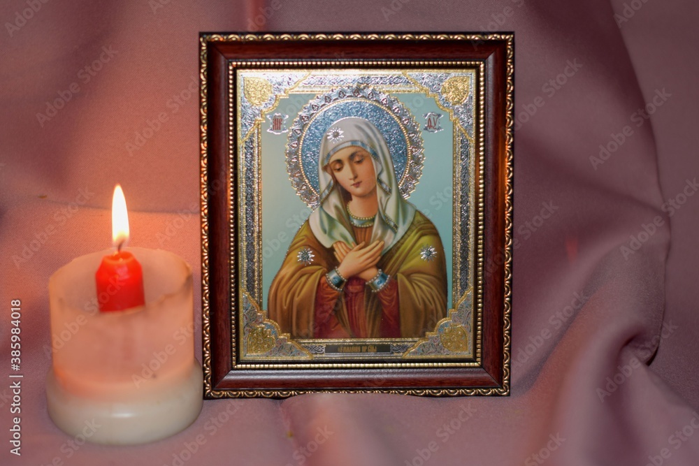 christmas candle and the image of the Saint in the Church