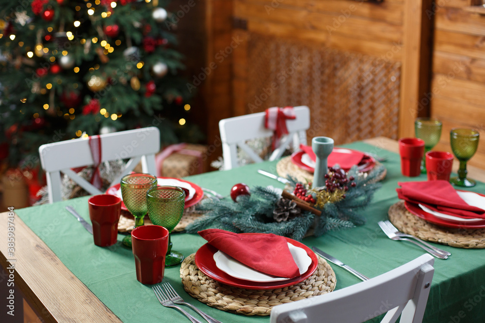 Christmas tablecloth with traditional green and red colors. Christmas  decorated kithen in loft style. Brown, green and red colors. Classic style  of interior in countryside decorated for New Year Eve Stock Photo