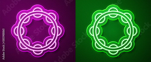 Glowing neon line Musical instrument percussion tambourine, with metal plates icon isolated on purple and green background. Vector.