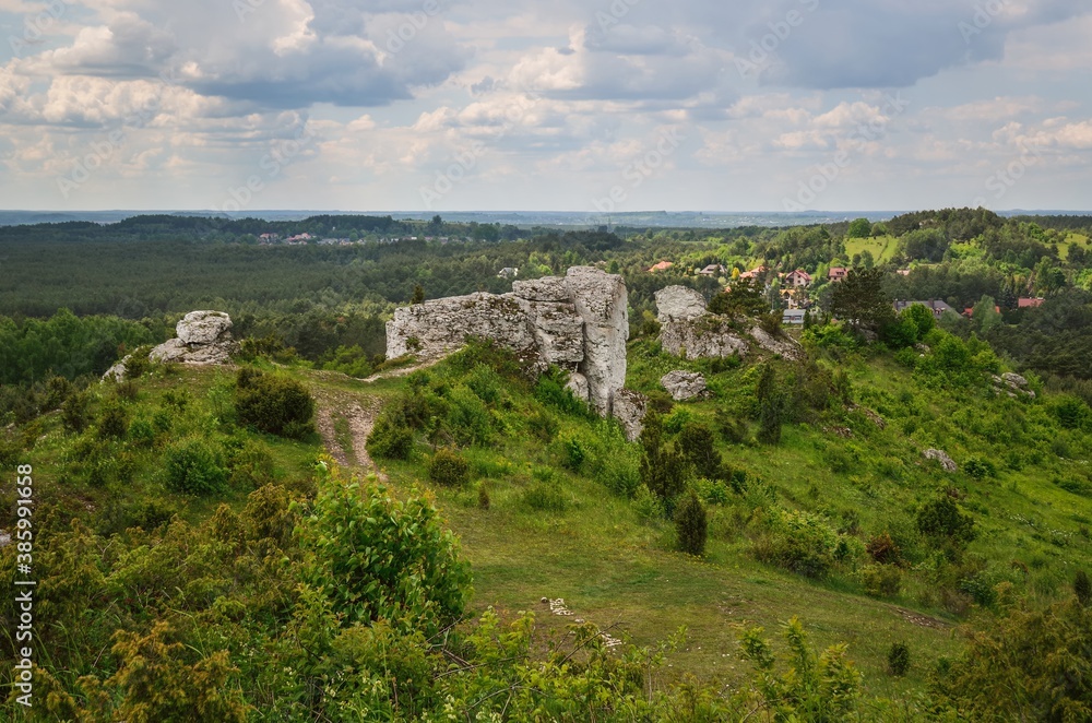Green rural landscape. Beautiful rocks in the town of Olsztyn in Poland.