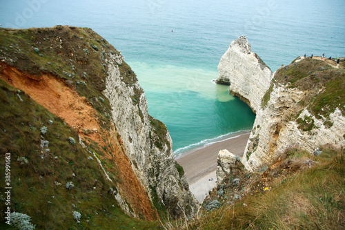 The nice high cliffs on the shore by the city of Étretat in Normandy in France. Famous tourist attraction. 