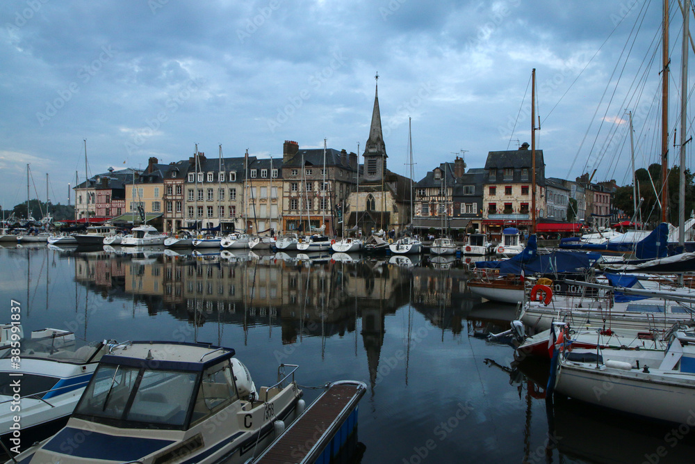 The nice and famous city of Honfleur in Normandy in France during the nice evening. The calm city with old houses. 