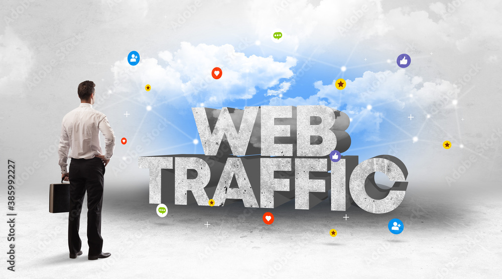 Young businessman standing in front of WEB TRAFFIC inscription, social media concept Young businessman standing in front of WEB TRAFFIC inscription, social media concept